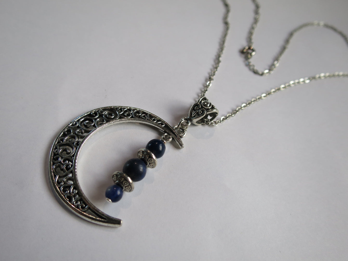 Silver filigree moon pendant with lapis lazuli