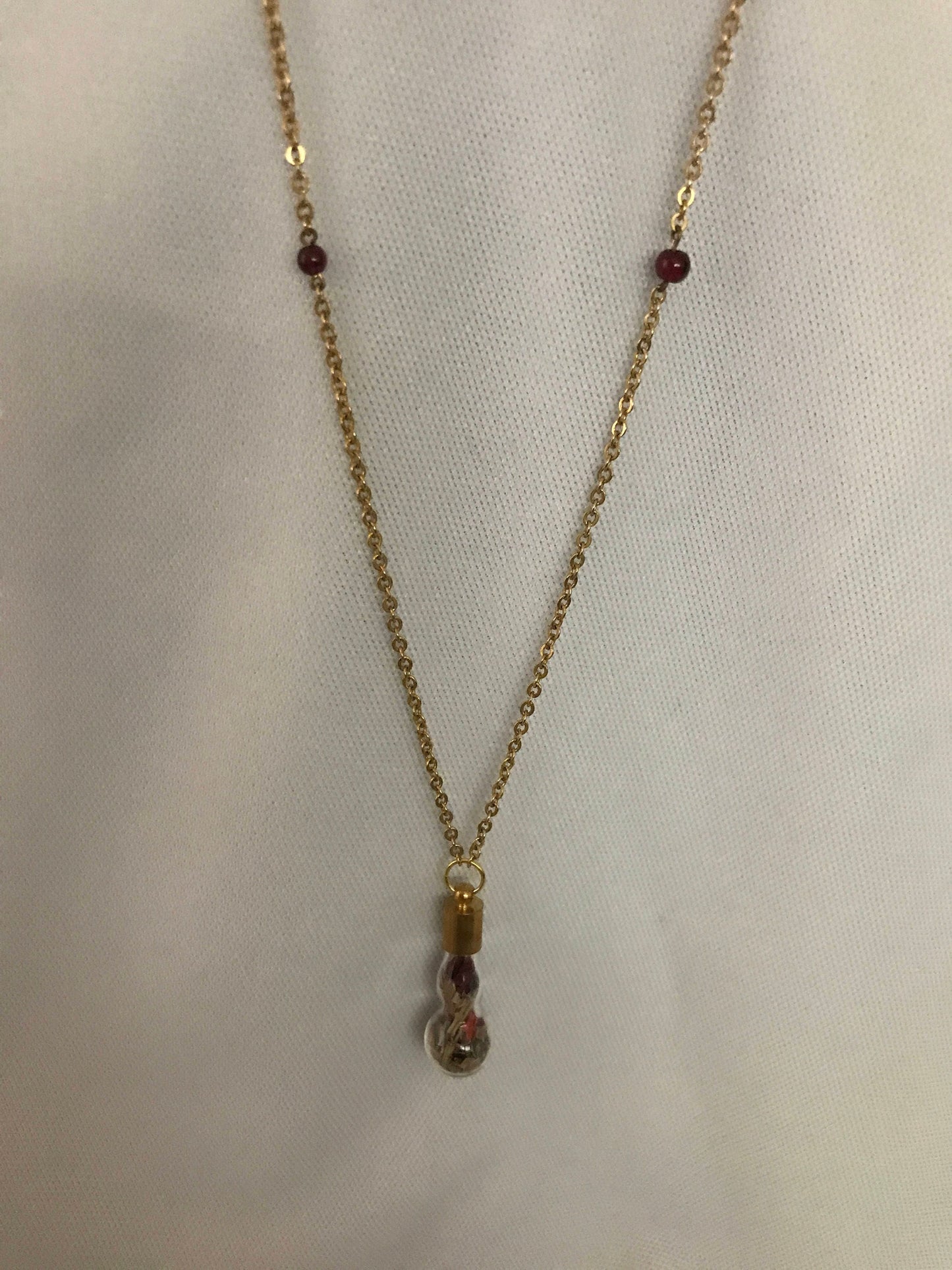 Love charm necklace, with a garnet chain.