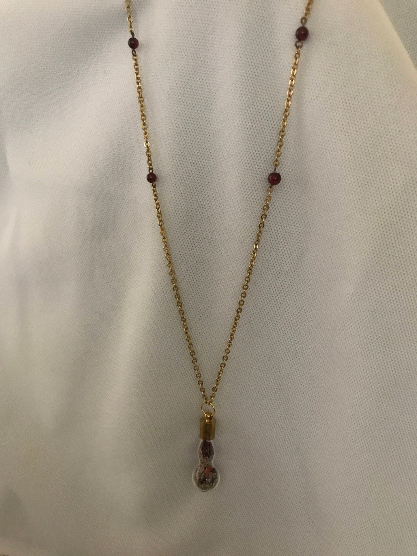 Love charm necklace, with a garnet chain.