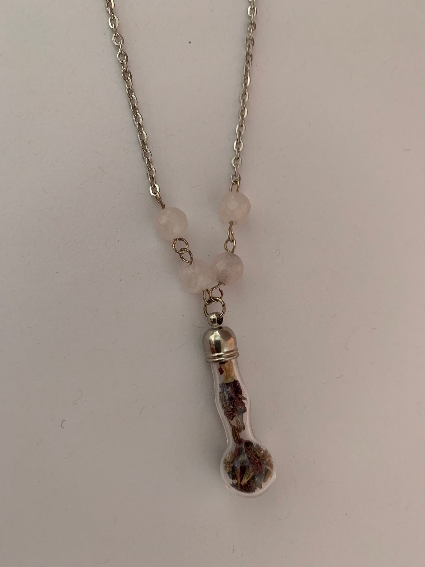 Talisman necklace, love charm spell bottle.