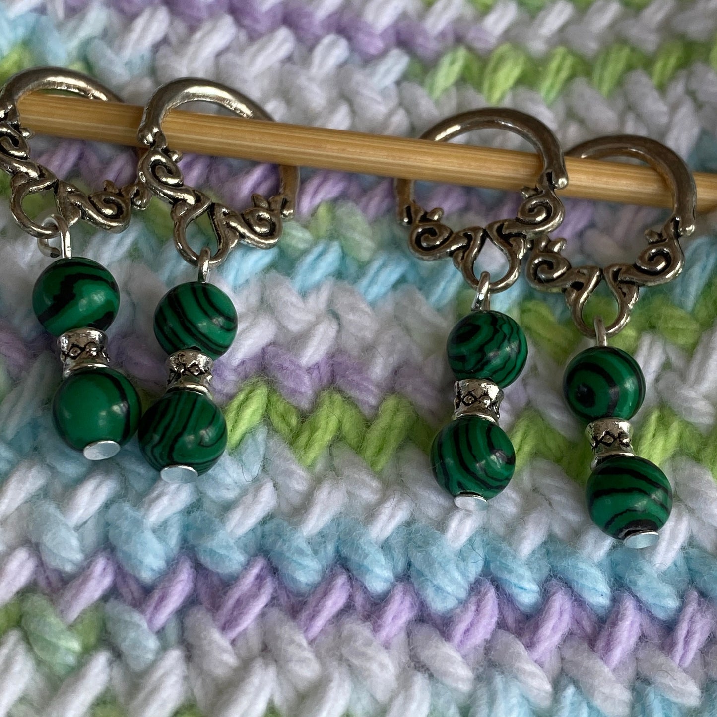 Malachite gemstone stitch markers with scroll loops